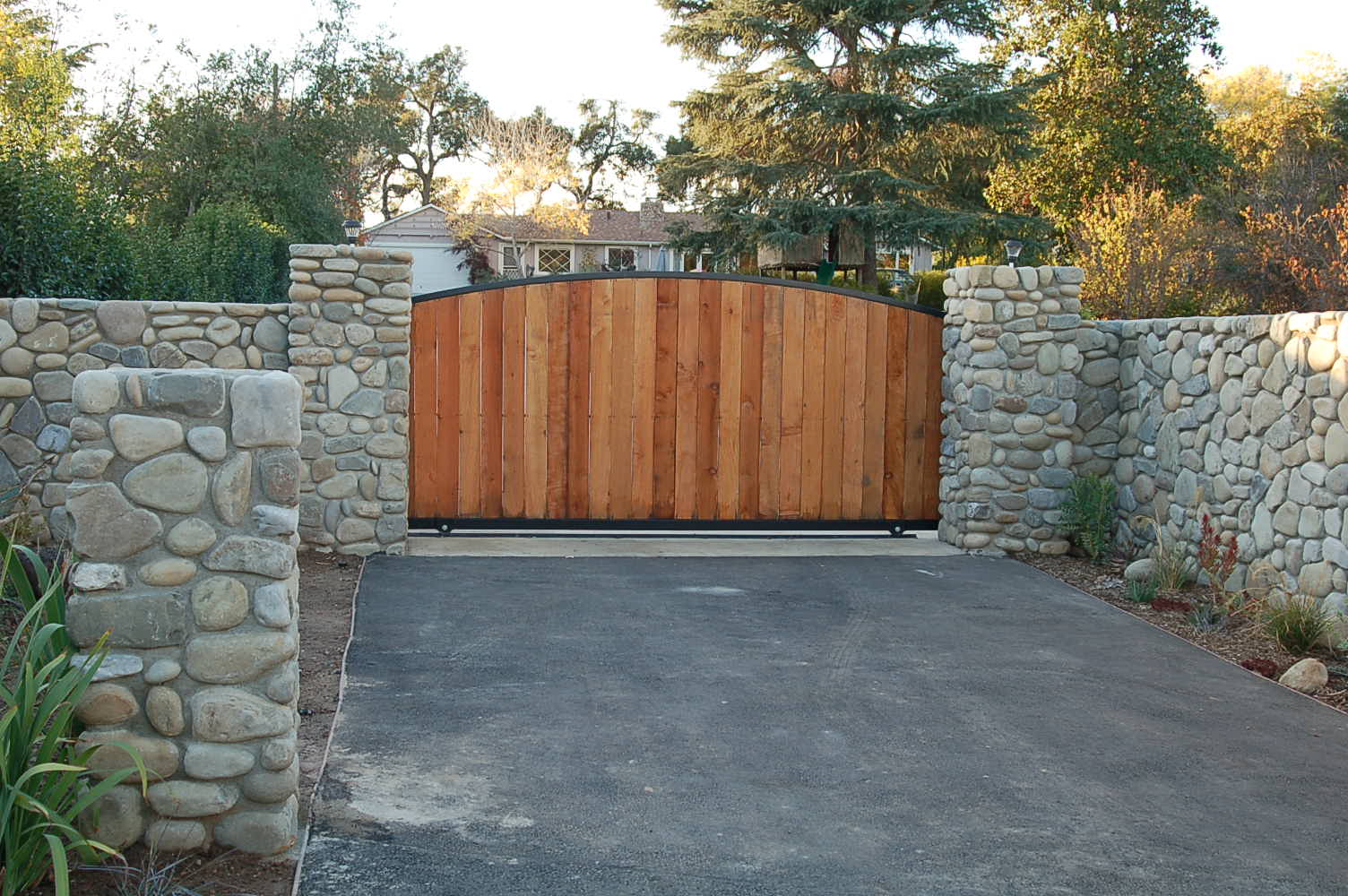 arched-wood-slide-gate-river-rock