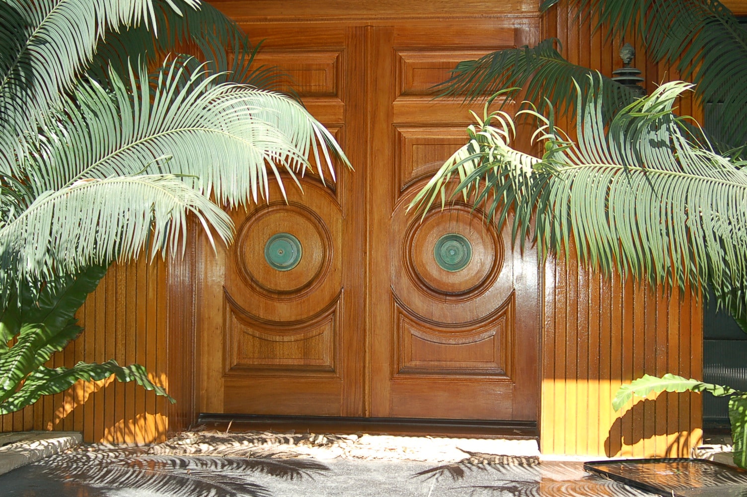 carved-wood-gates-bronze-medallions