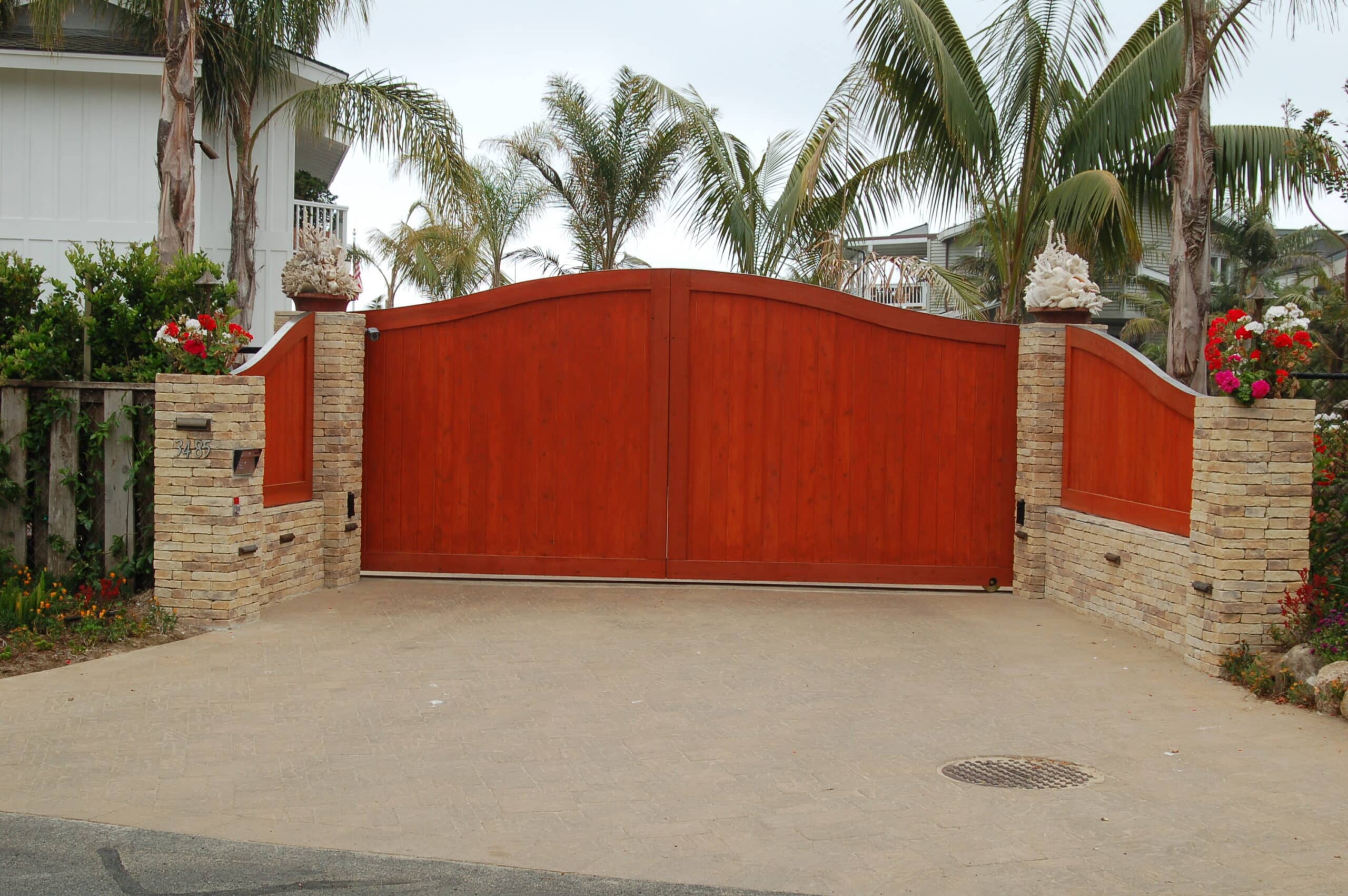red-wood-driveway-gate-stone-pillars