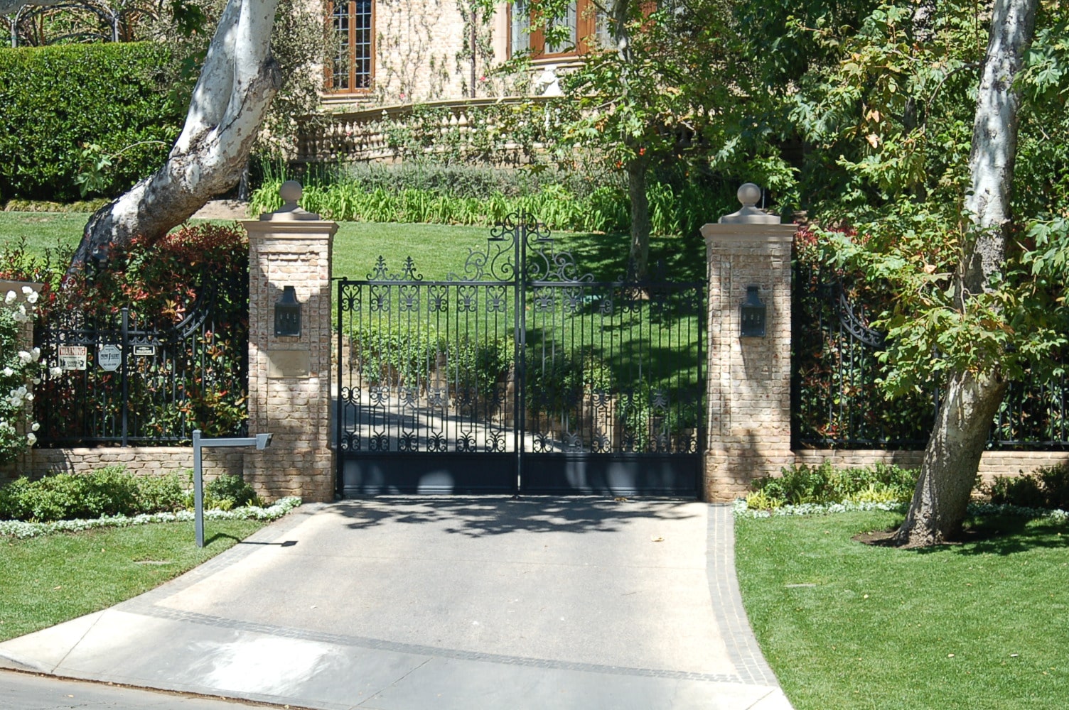 wrought-iron-swing-gates-brick-pillars